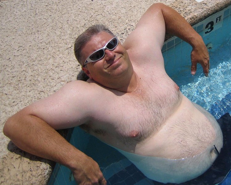big husky macho man beefy bear swimming poolside