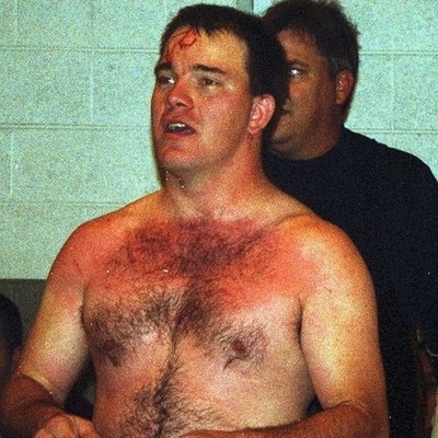 college dude wrestler with hairy nips bleeding face from grappling cage match