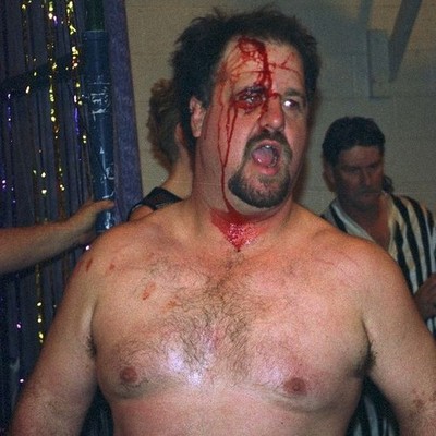 black eye moustache hairy man fighting men in cage match