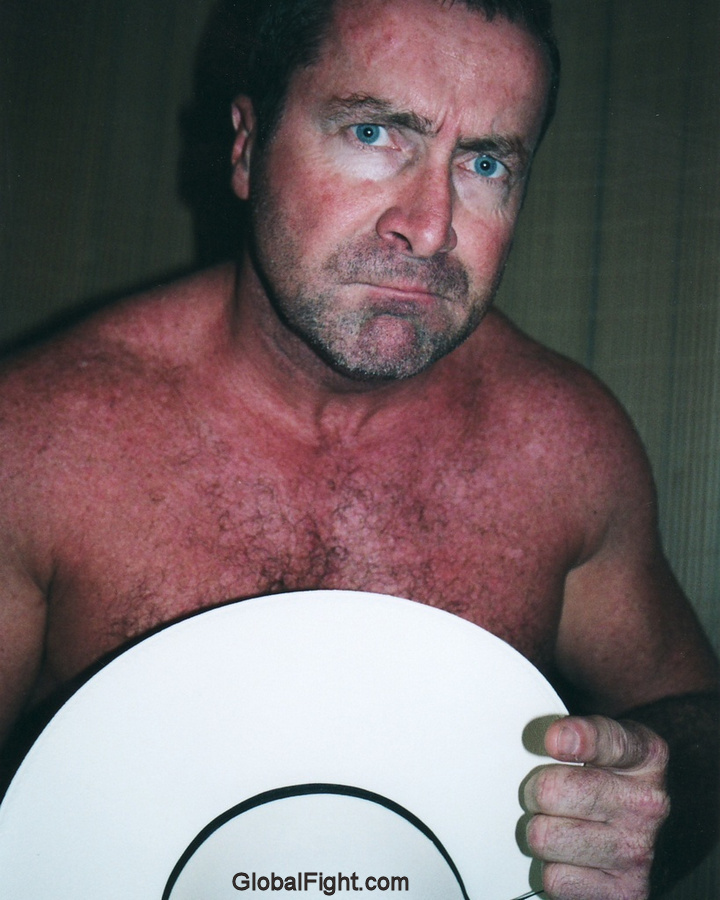 naked cowboy removing hat shirtless